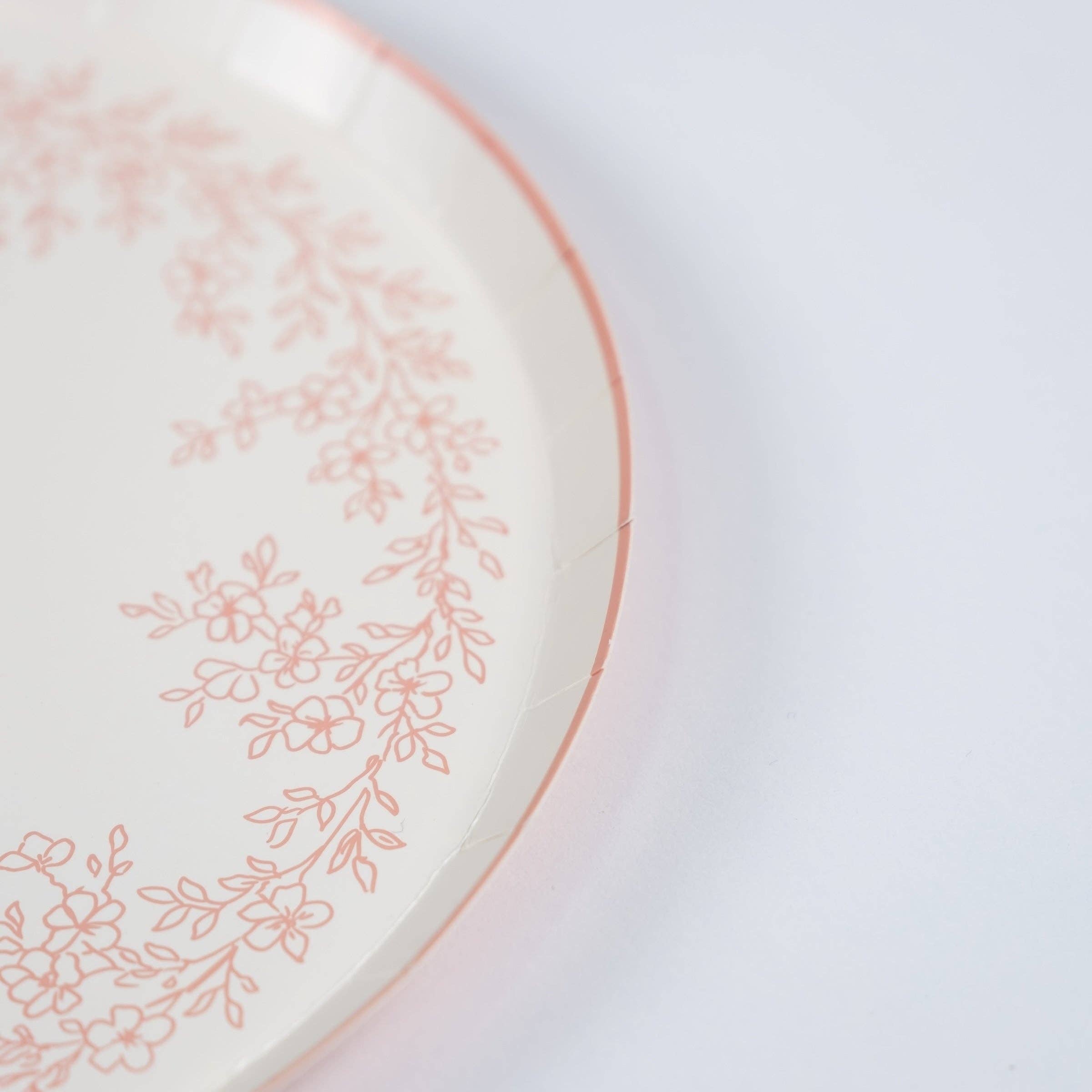 Close-up of scalloped edge on pink floral dessert plate