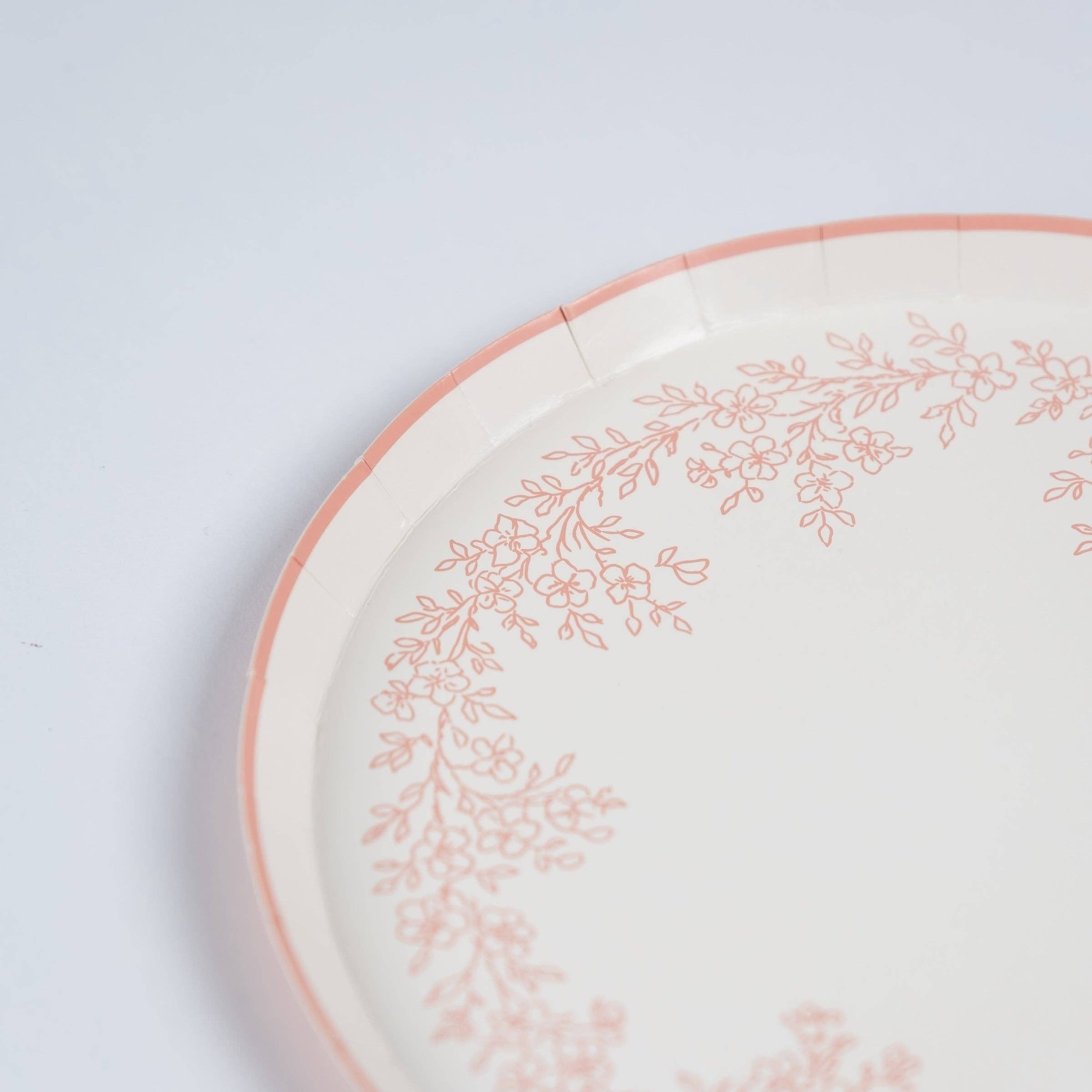 Close-up of scalloped edge on pink floral dessert plate