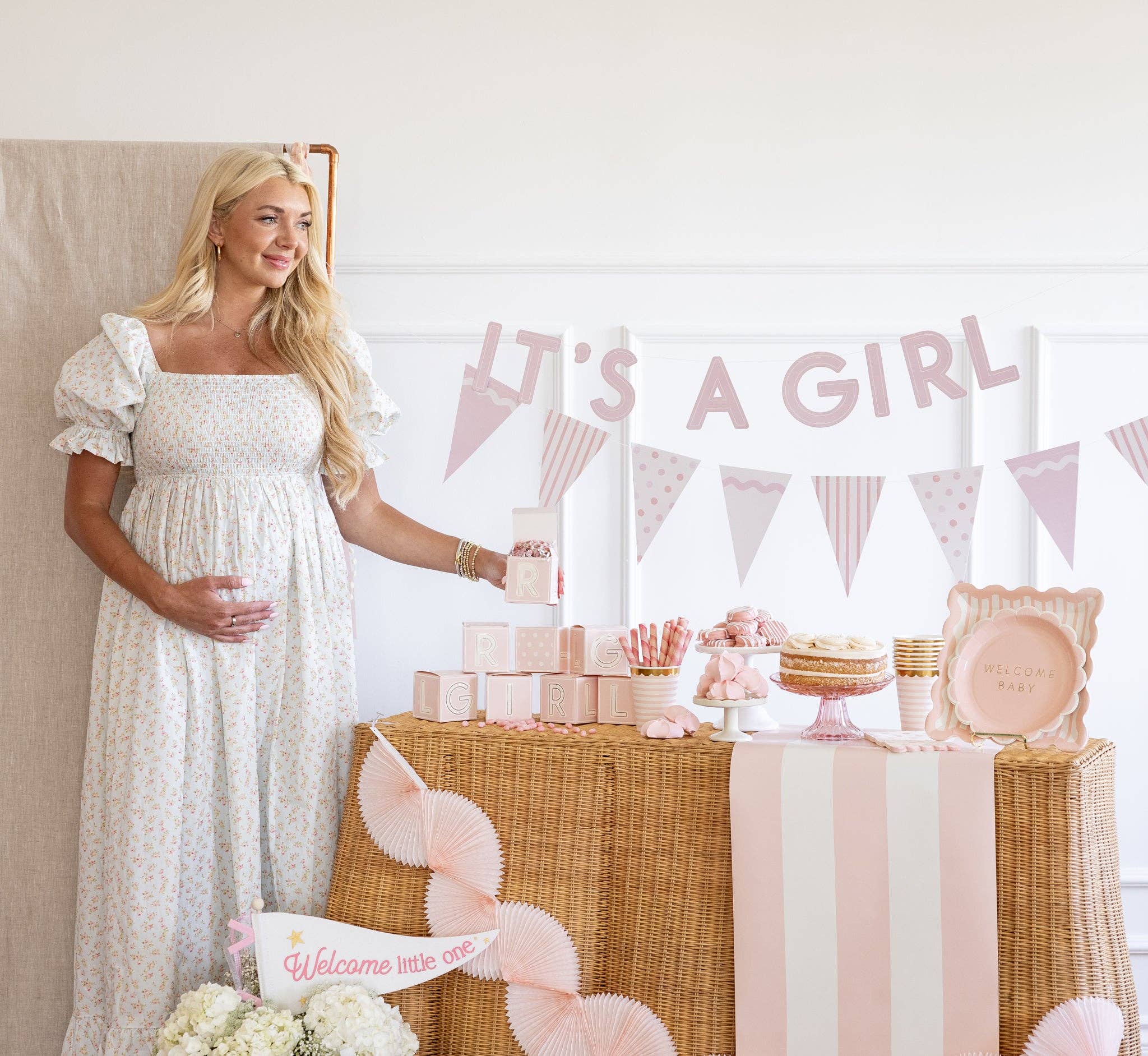 Pink striped table runner styled on a baby shower dessert table