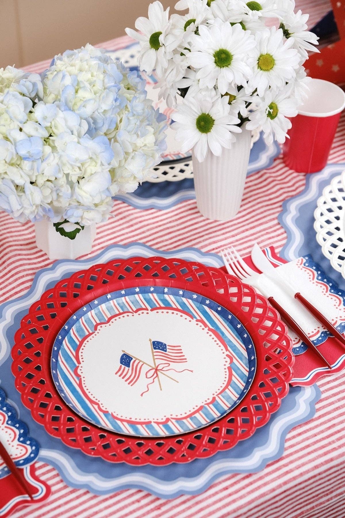American Flag Paper Plates styled with hydrangeas and daisies for a Coastal Americana Aesthetic.