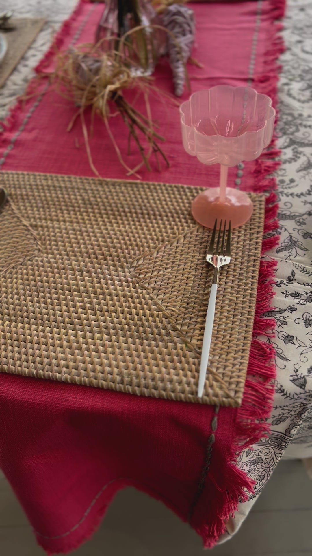 Rectangle rattan placemat in a white wash color on an Spring table. The perfect gift for someone who enjoys hosting.