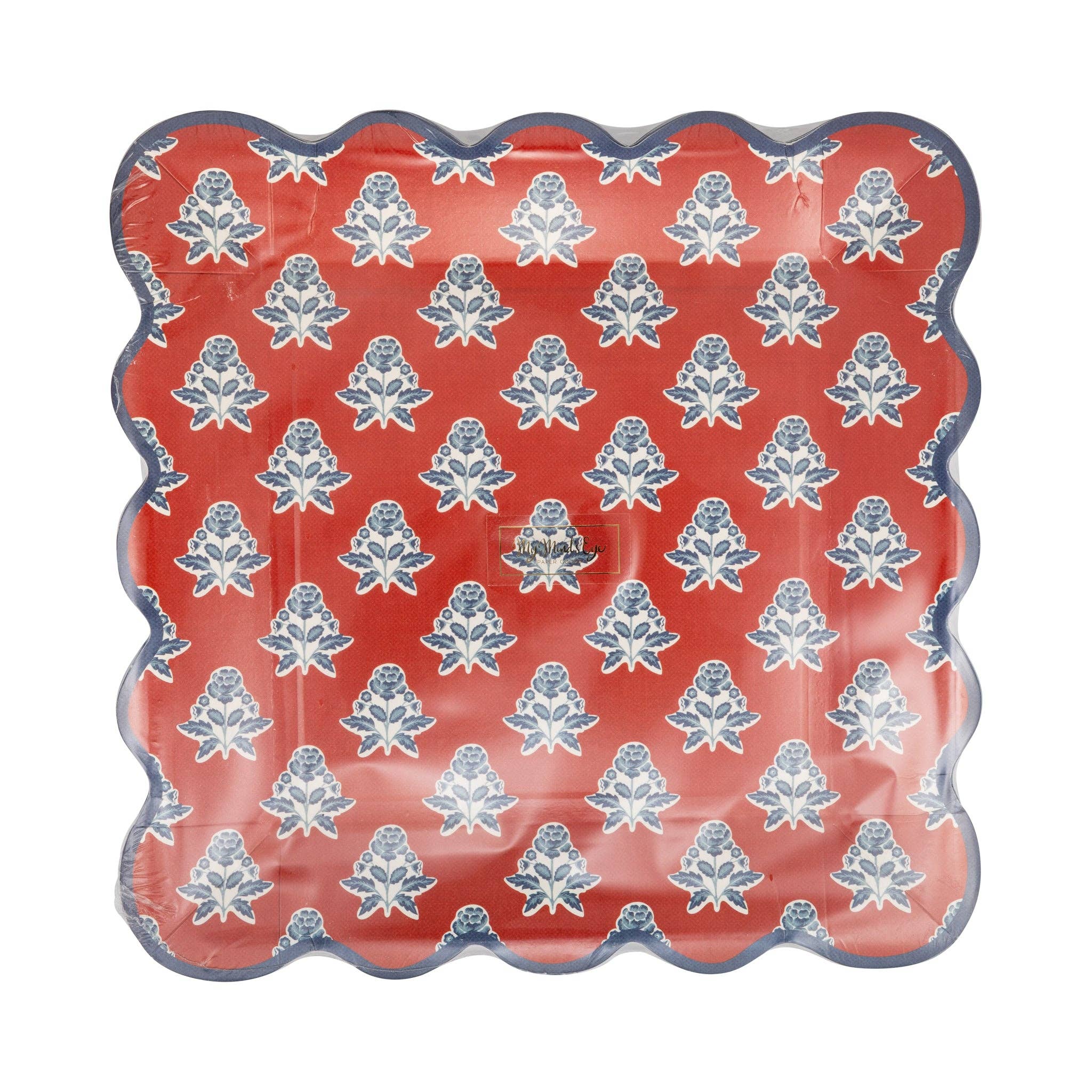 Red block print floral scalloped paper plate with blue and cream floral motif and navy scalloped edge shown in packaging