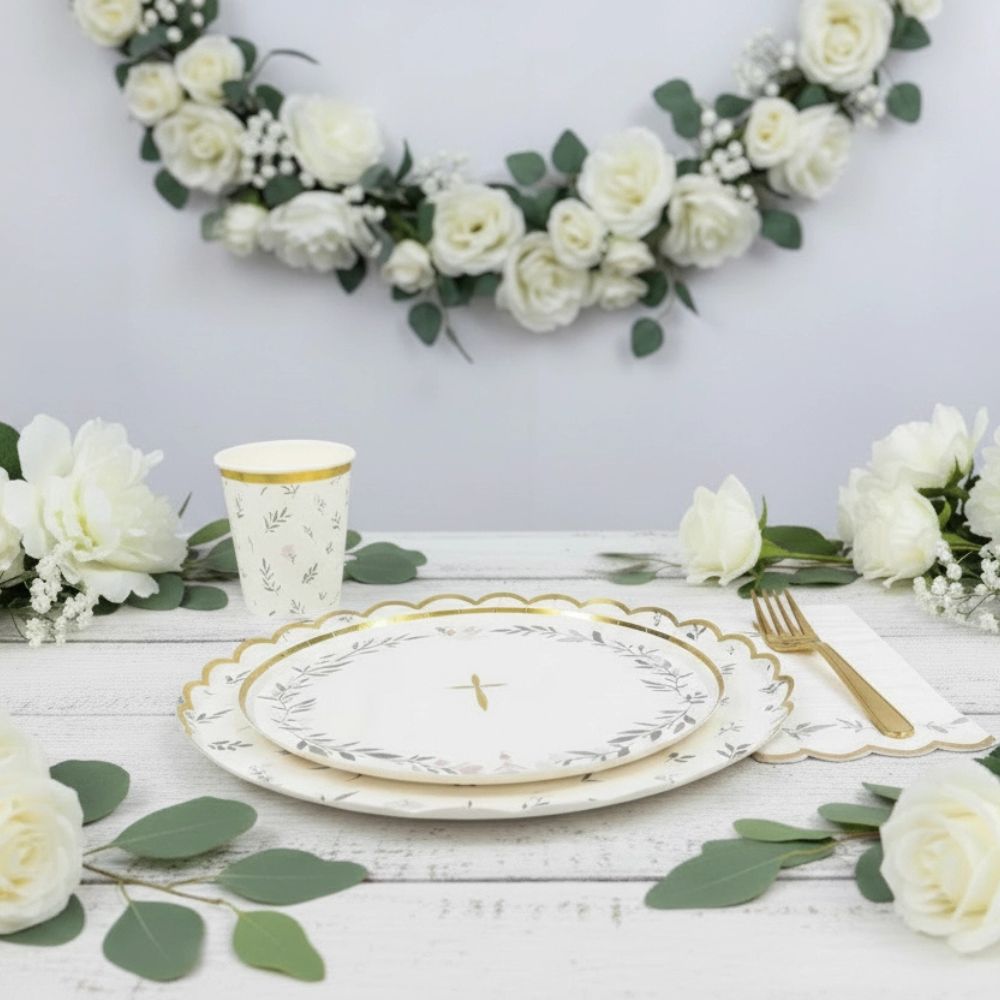 religious table decor with floral greenery plates and cups
