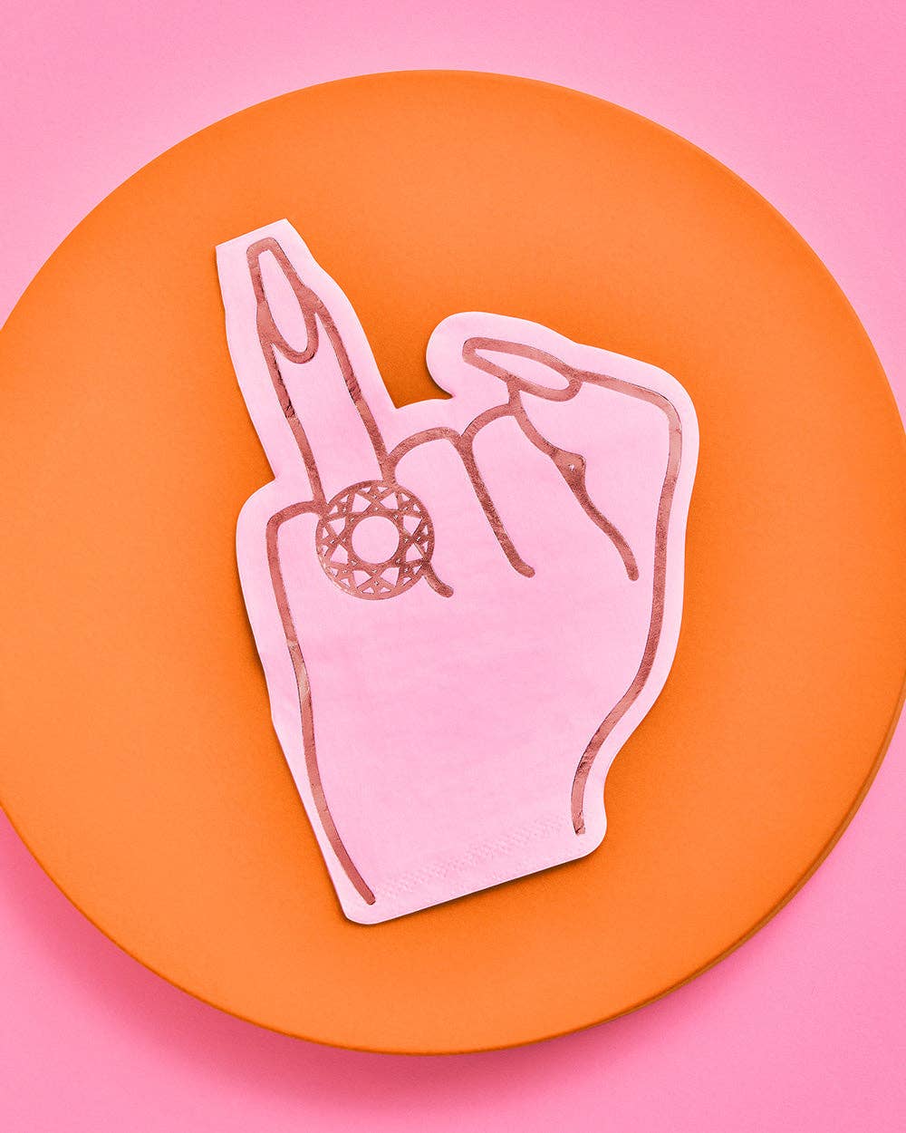 Multiple pink ring finger die-cut napkins scattered on pink and orange background showing hot pink foil diamond ring hand design