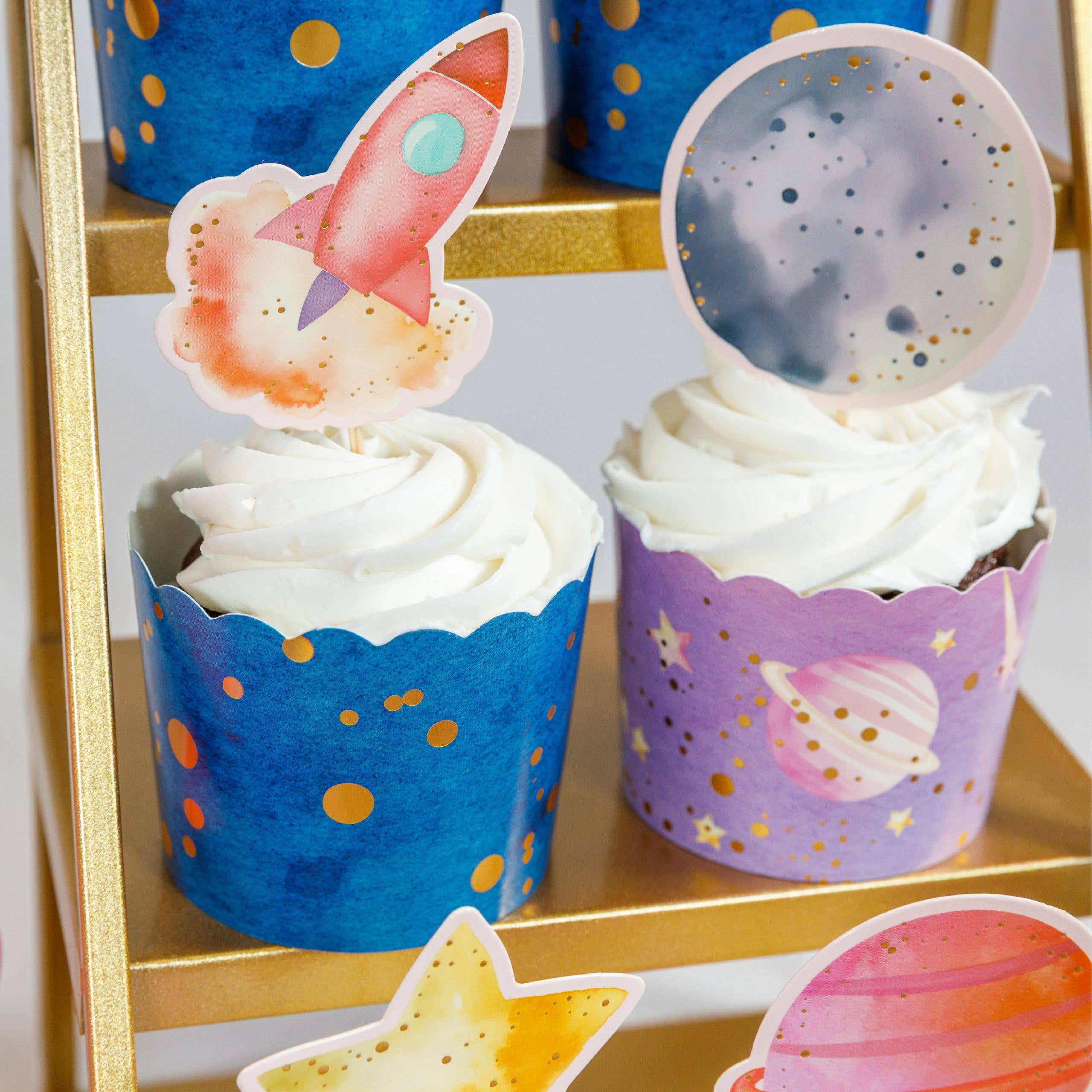 rocket and moon cupcake toppers on space themed cupcakes