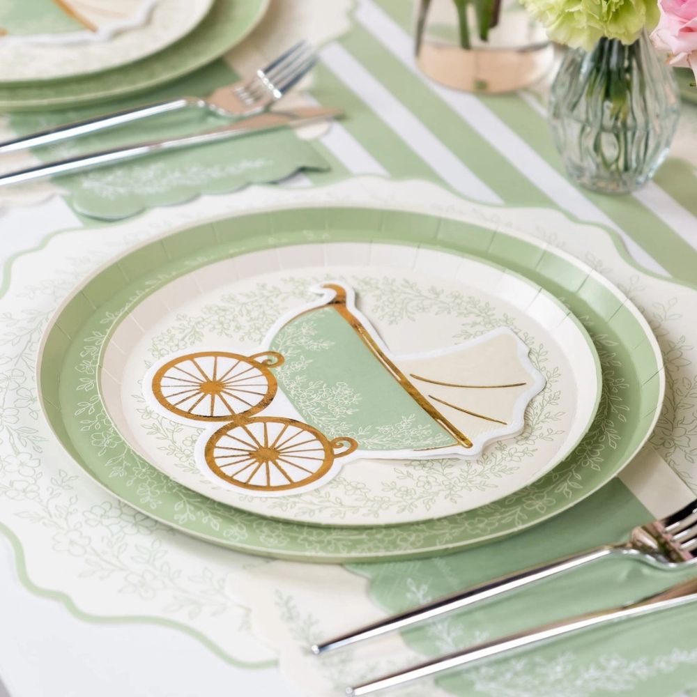 sage placemat layered under baby shower dinner plates and napkin.