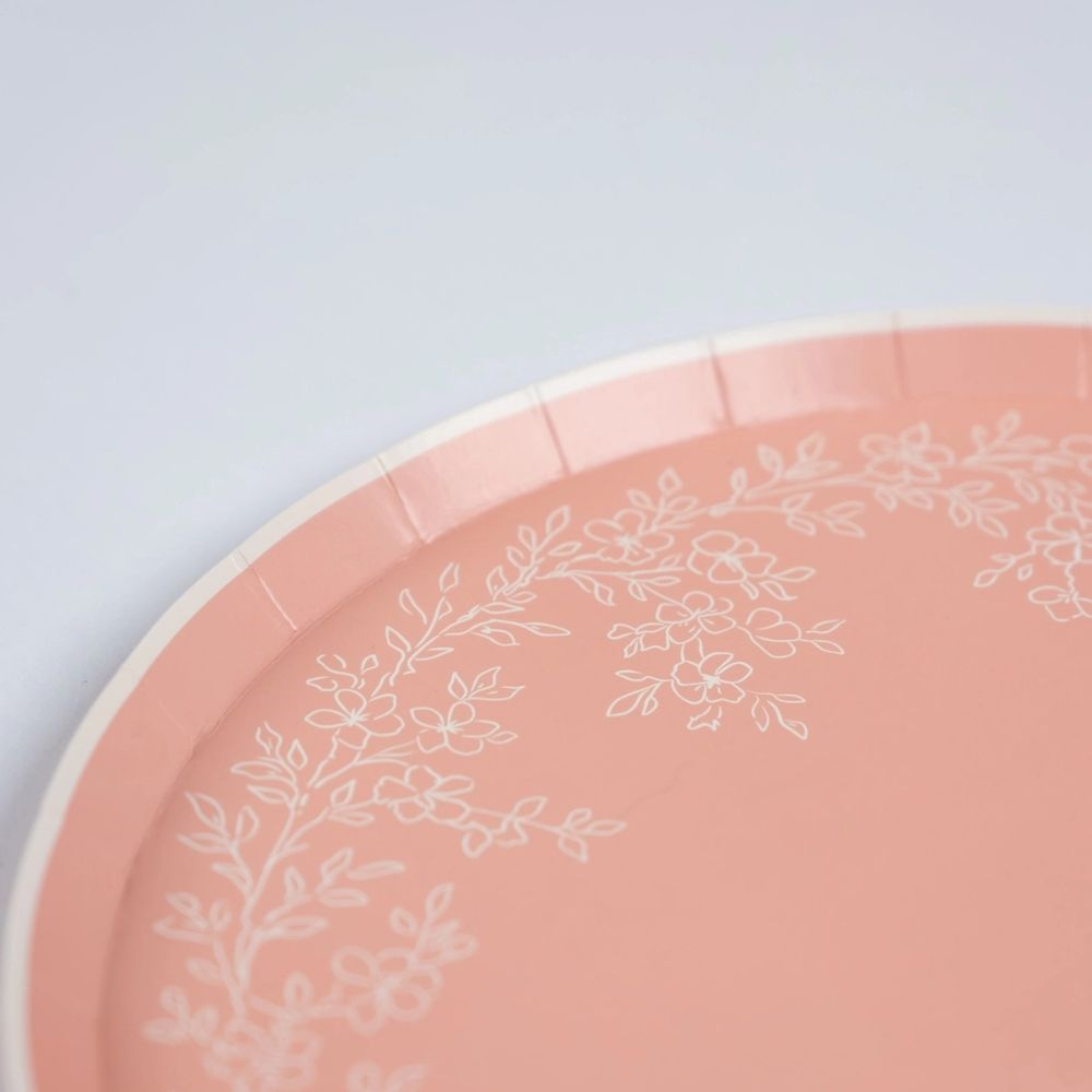 Close-up of scalloped edge on pink dinner plate