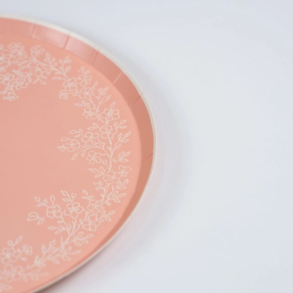 Close-up of scalloped edge on pink dinner plate