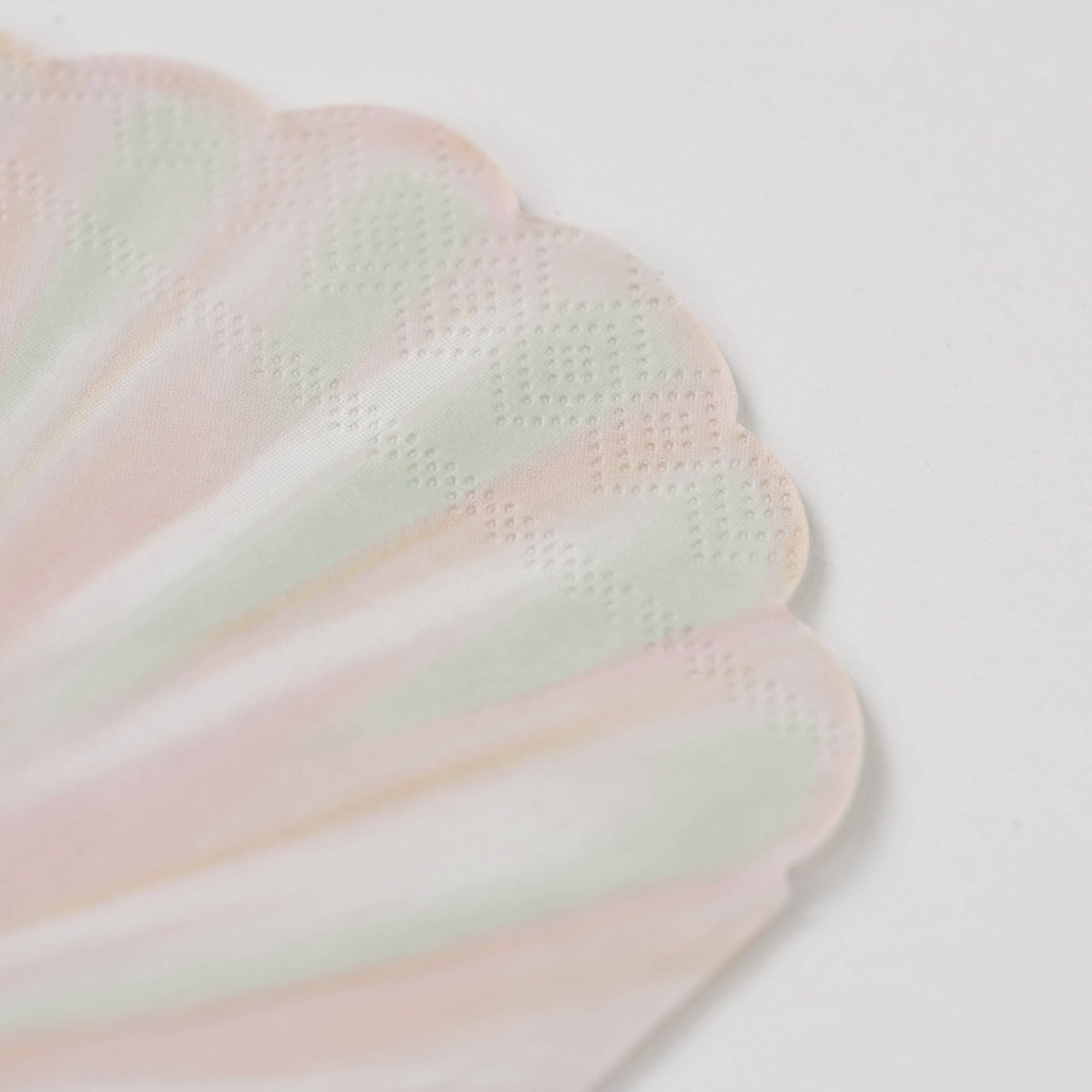 detail of scalloped edge on sea shell napkins.