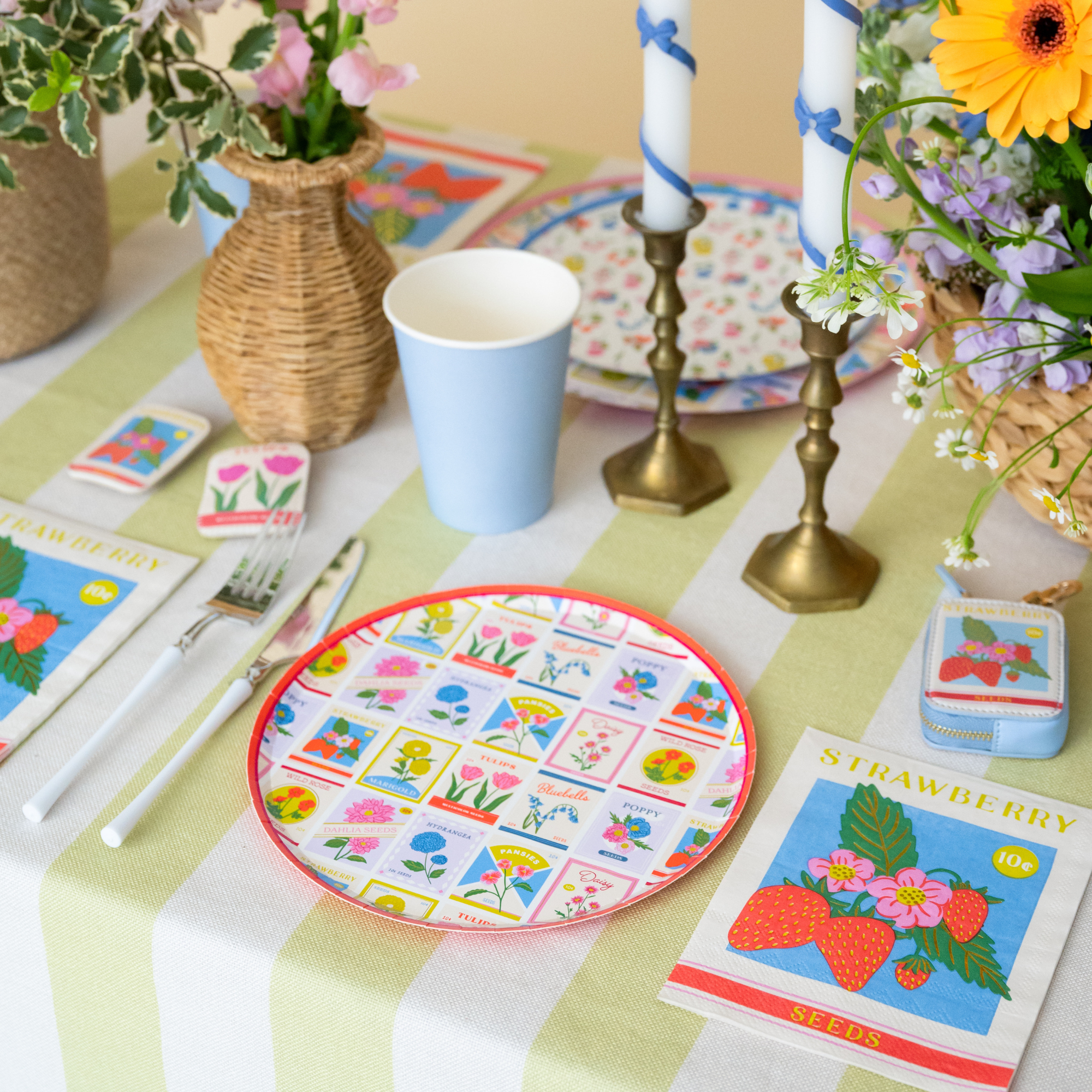 In Bloom seed packet dessert plate styled on a spring table with flowers, candles, and pastel décor