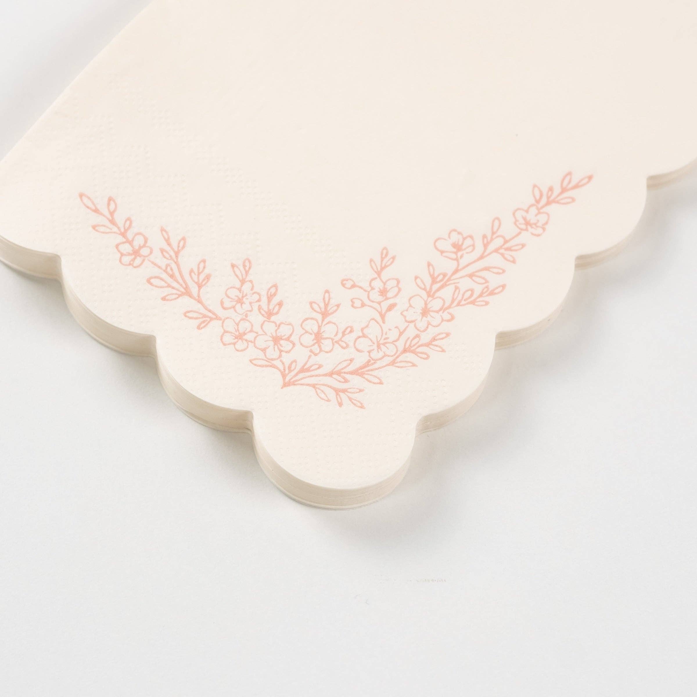 Detailed view of the intricate blush pink floral blossoms and leafy sprigs