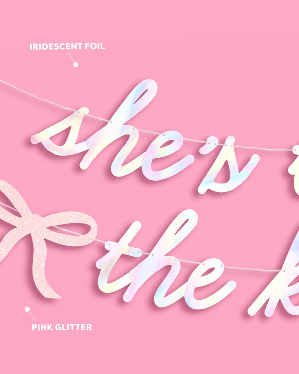 She's Tying the Knot banner showing iridescent foil lettering and pink glitter bow material details on pink background