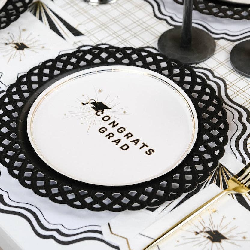 A Congrats Grad plate resting on a black lattice charger for a polished Heritage Graduation Style table.