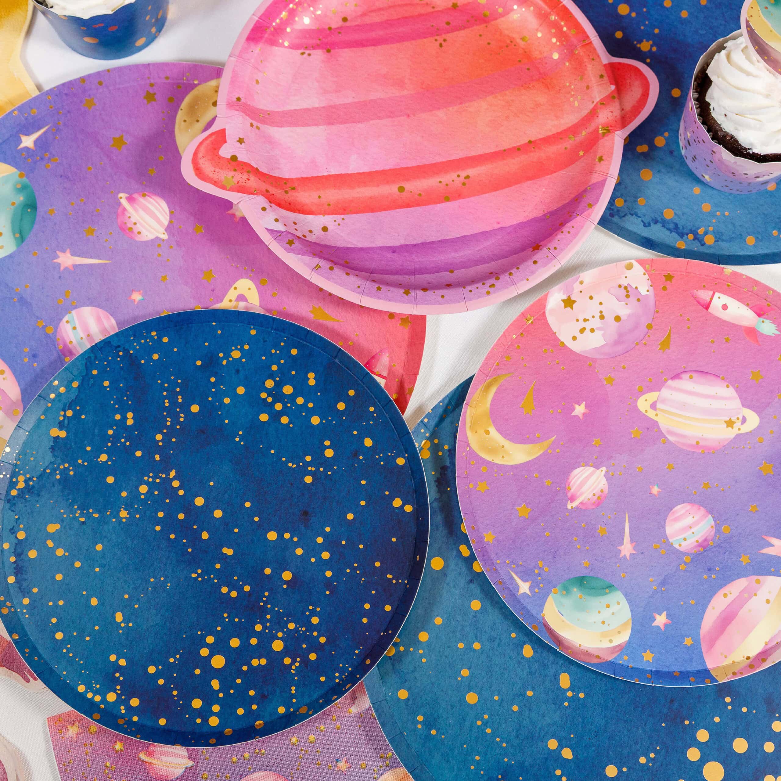 space party table with planet plates and matching galaxy tableware