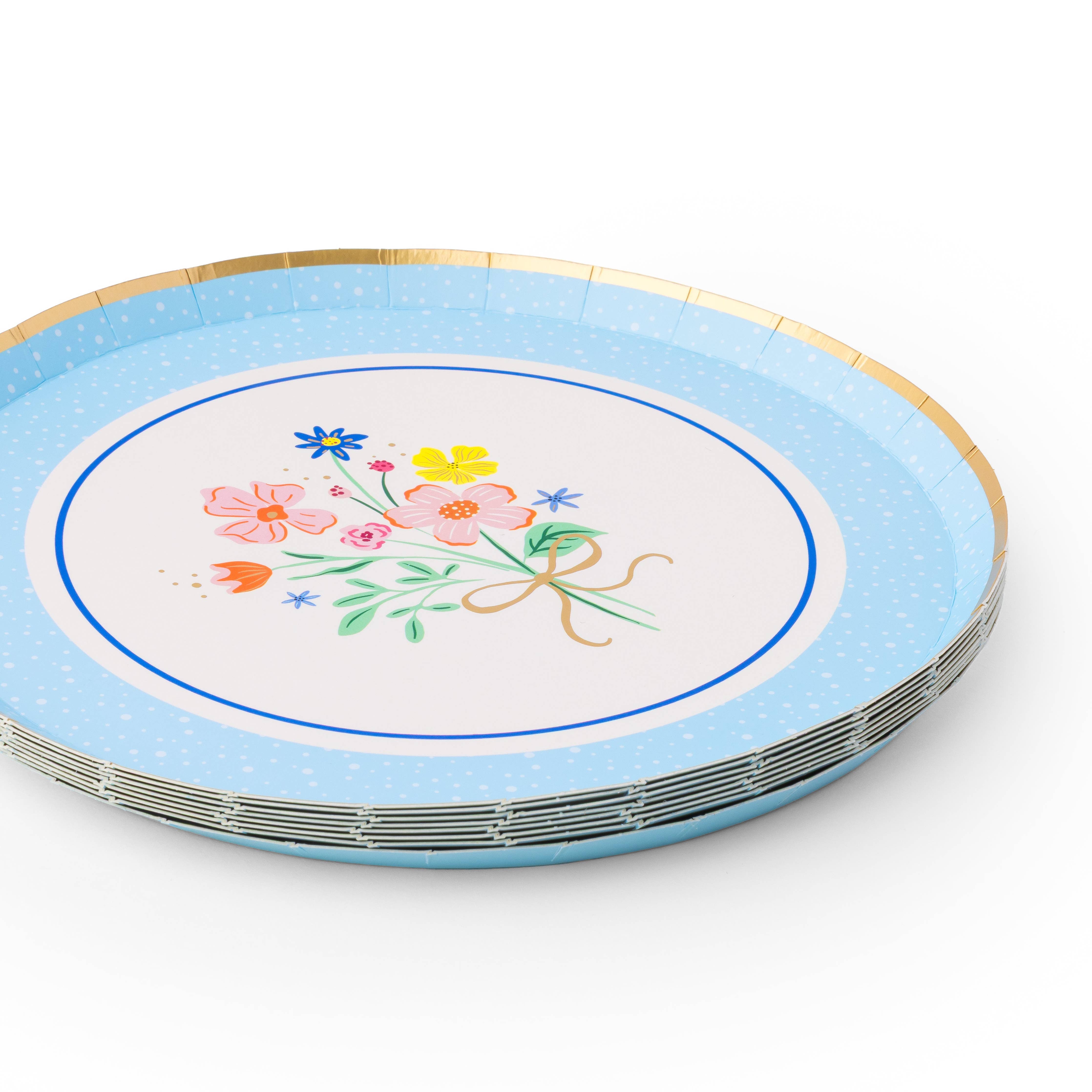 Stack of spring bouquet floral dessert plates with blue border and floral design