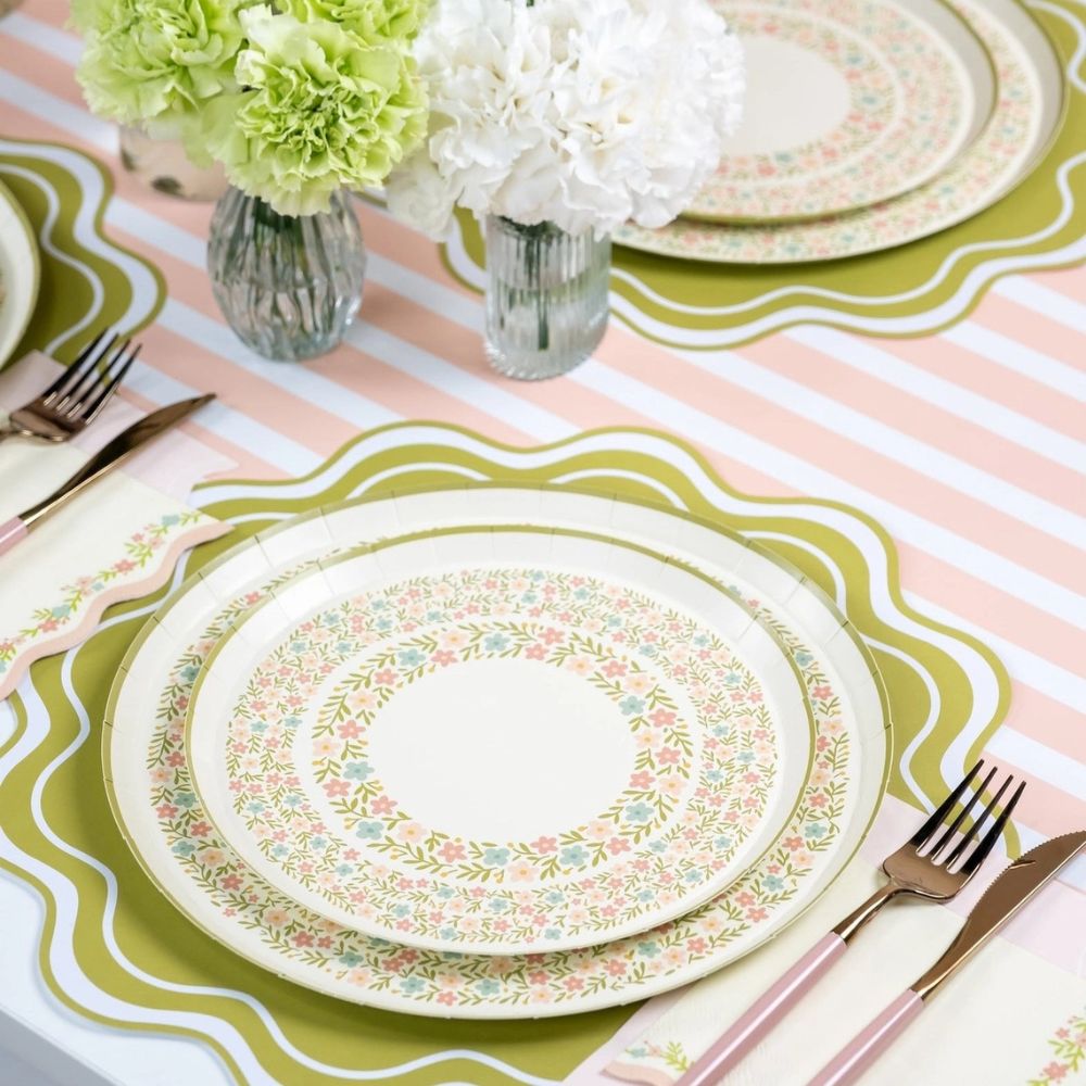 spring dinner plates styled on striped table setting.