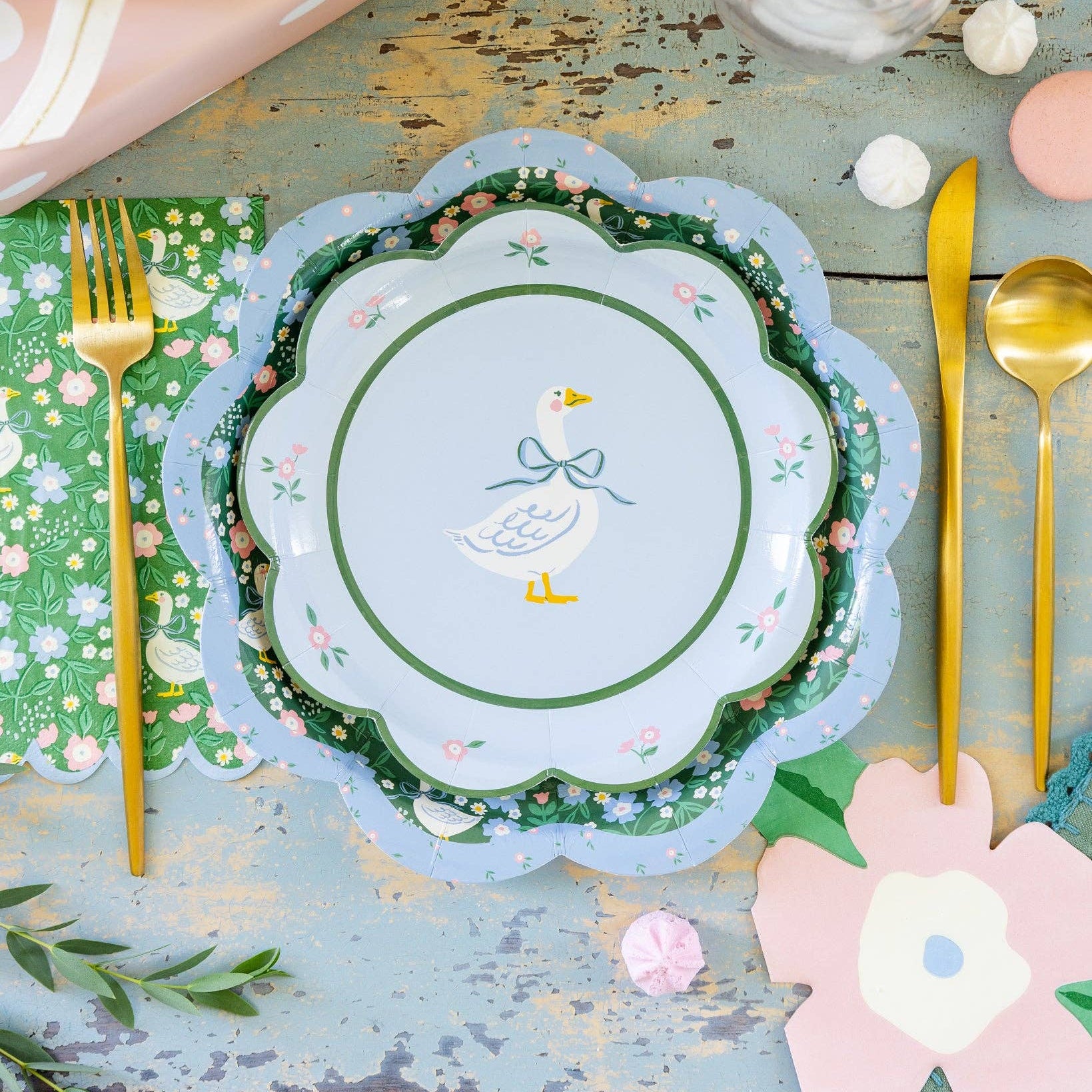 Spring table setting with floral plates and pink flower napkins for garden party
