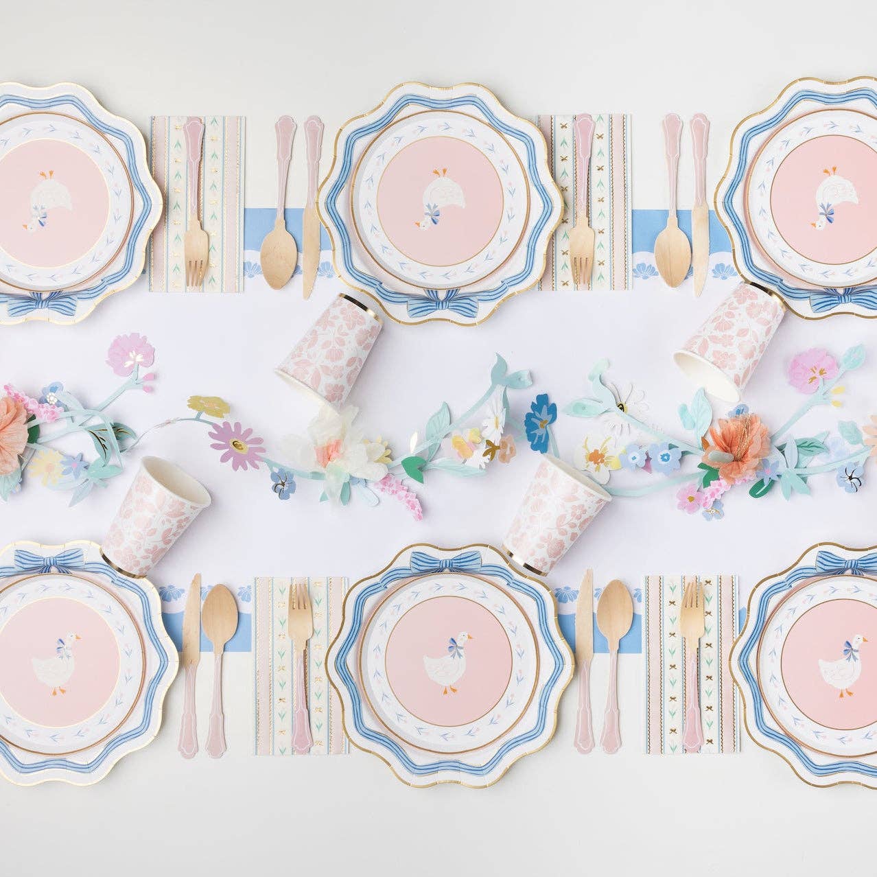 Spring table setting with floral plates, tulip guest towels, and pastel decorations