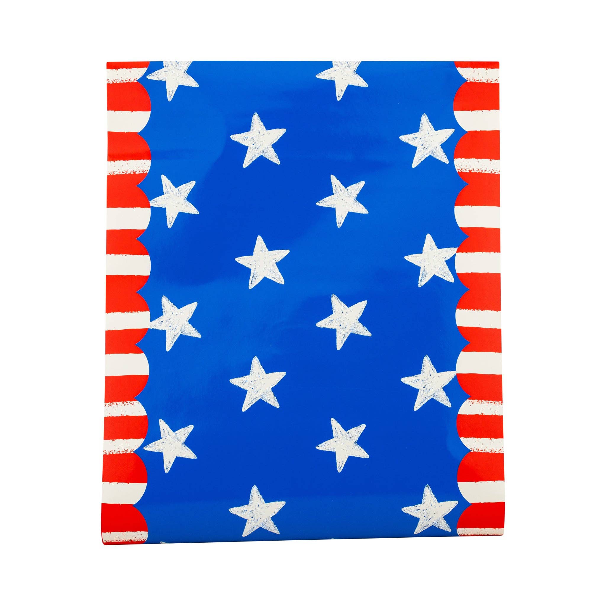 Flat lay of stars and stripes paper table runner showing blue background with cream hand-drawn stars and red and white striped scalloped borders