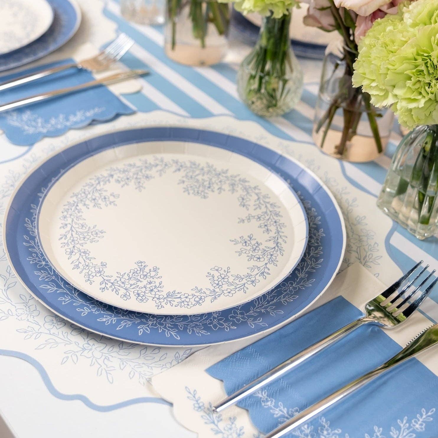 close up of blue table runner with plates and napkins
