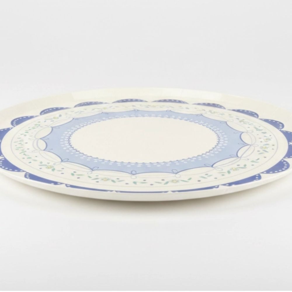 Side profile of a flat blue coquette plate showing durable construction
