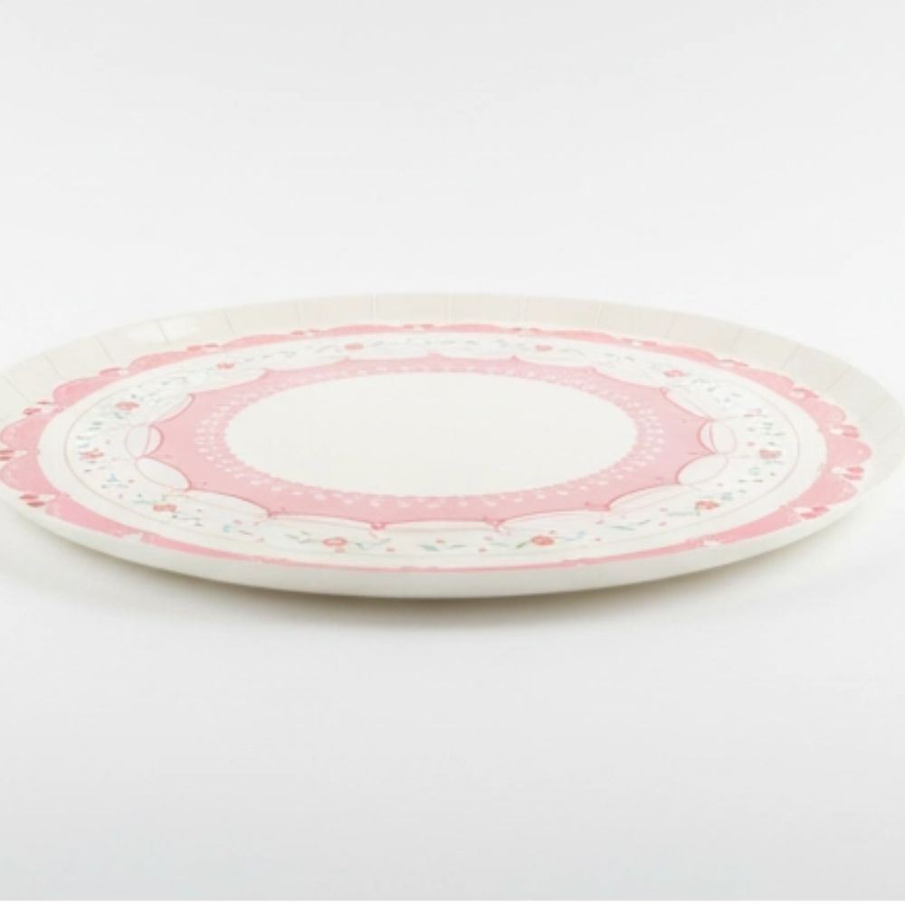 Side view of a flat cherry cake plate showing sturdy paper construction