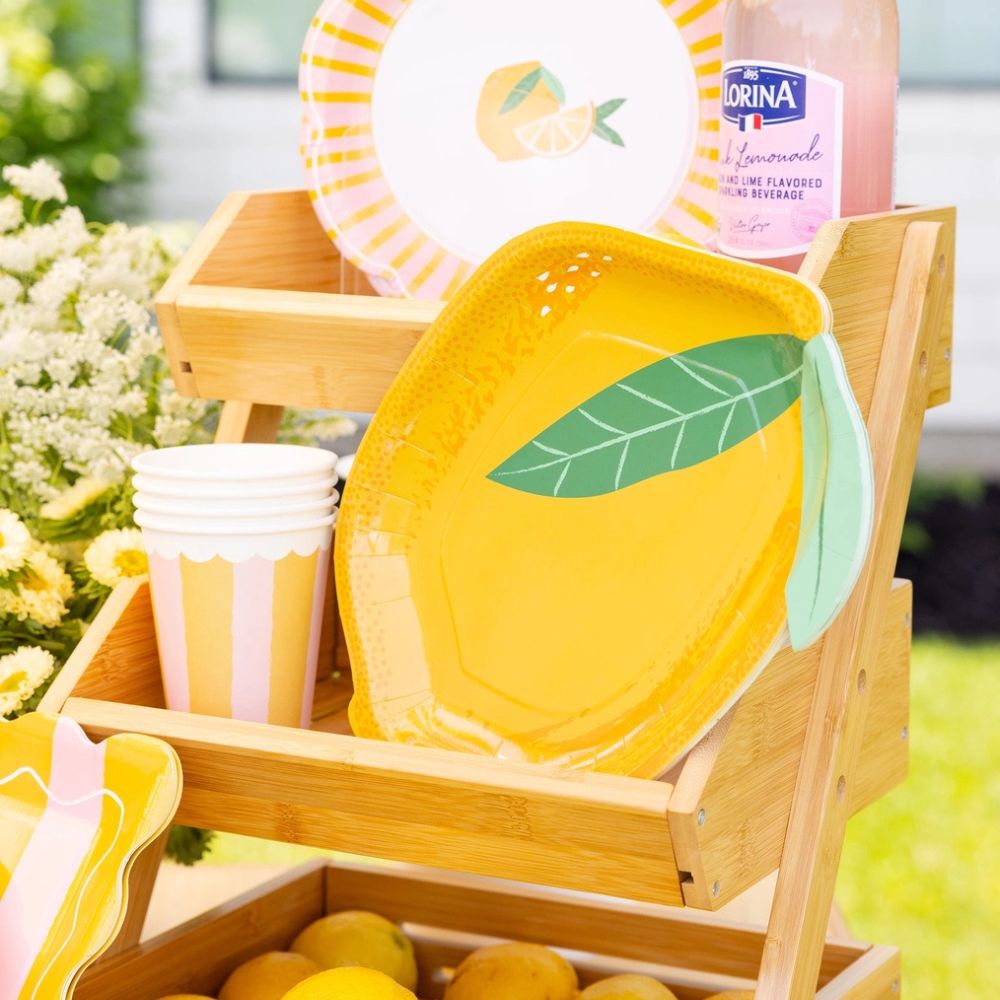 Lemon themed party table with striped cups and yellow decor