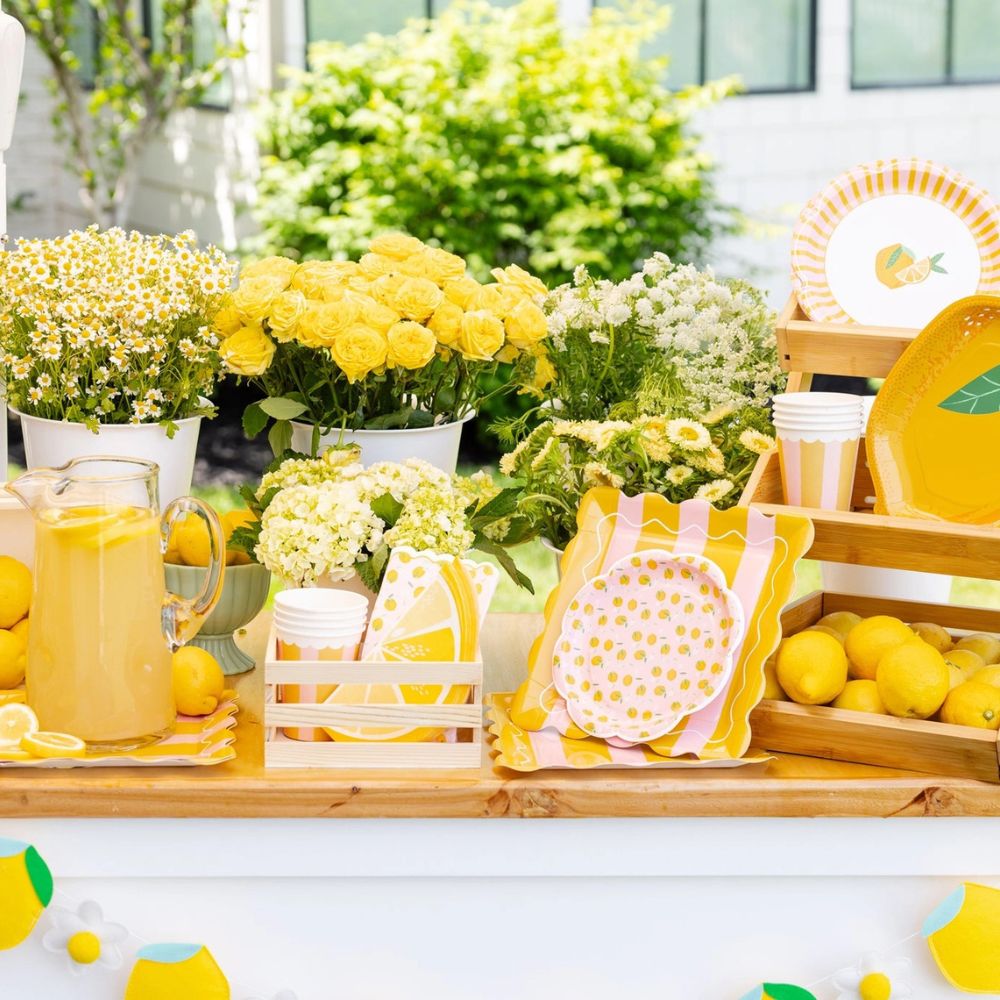 Lemon party table with square striped plates and flowers