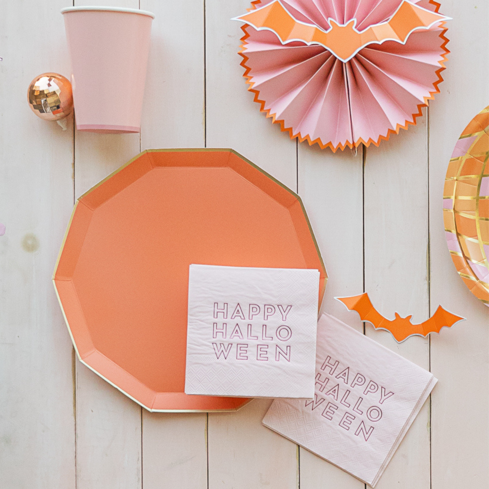 Sunkissed Orange plate styled with Happy Halloween napkins and pastel decor