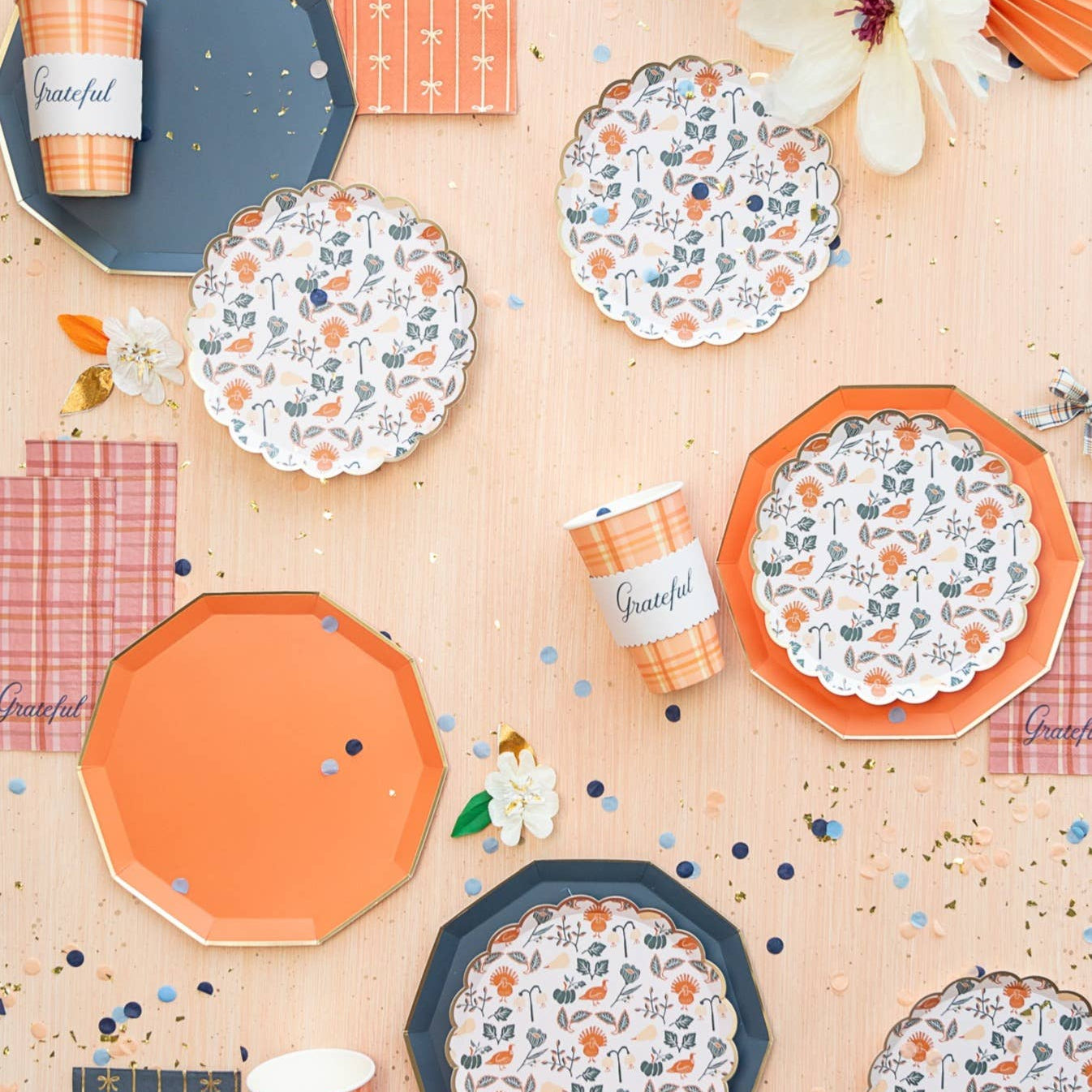Sunkissed Orange dinner plate styled in fall tablescape with floral patterned plates and plaid napkins
