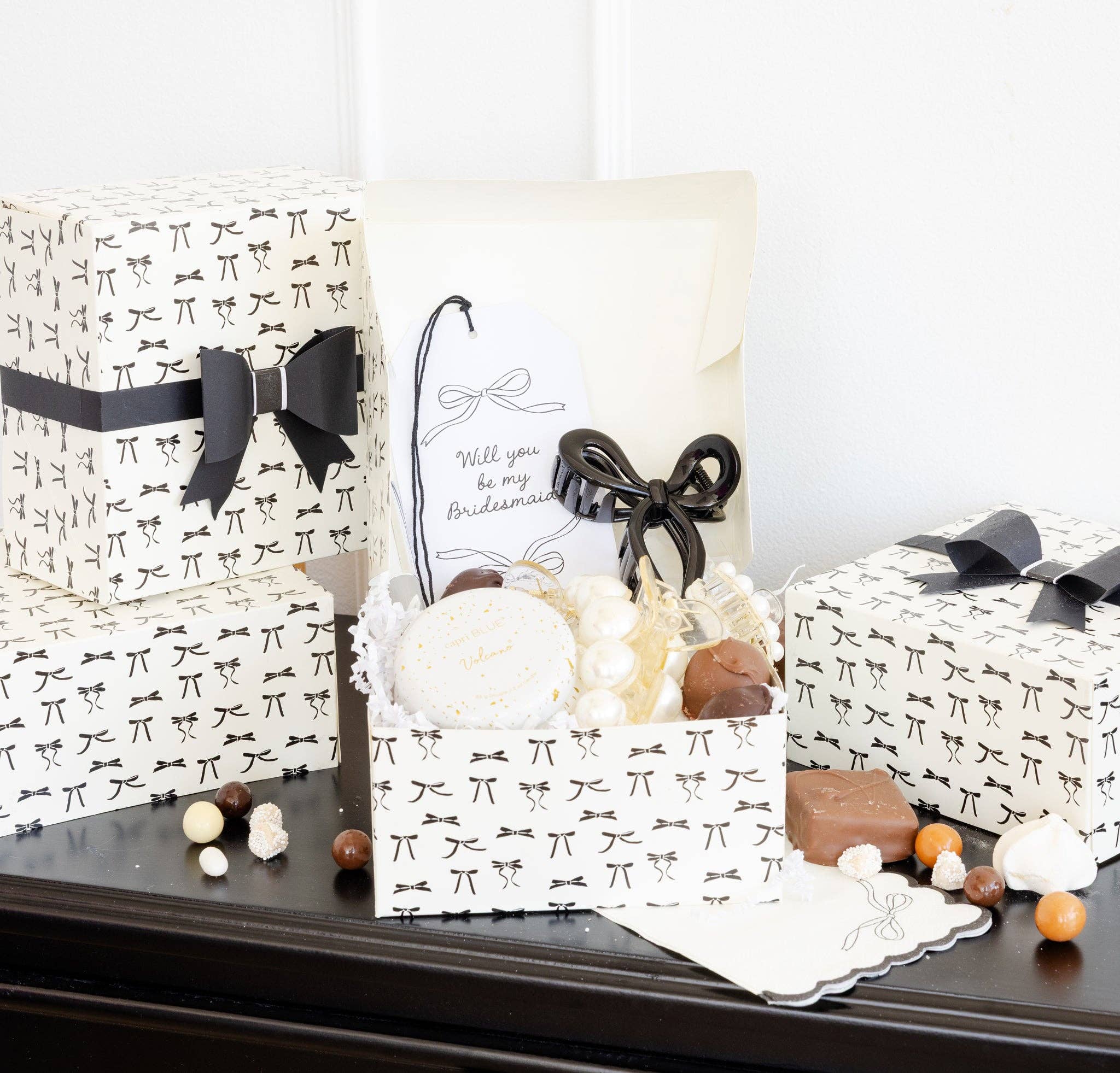 Open Tying the Knot Treat Box displayed with bridesmaid proposal items and sweets.