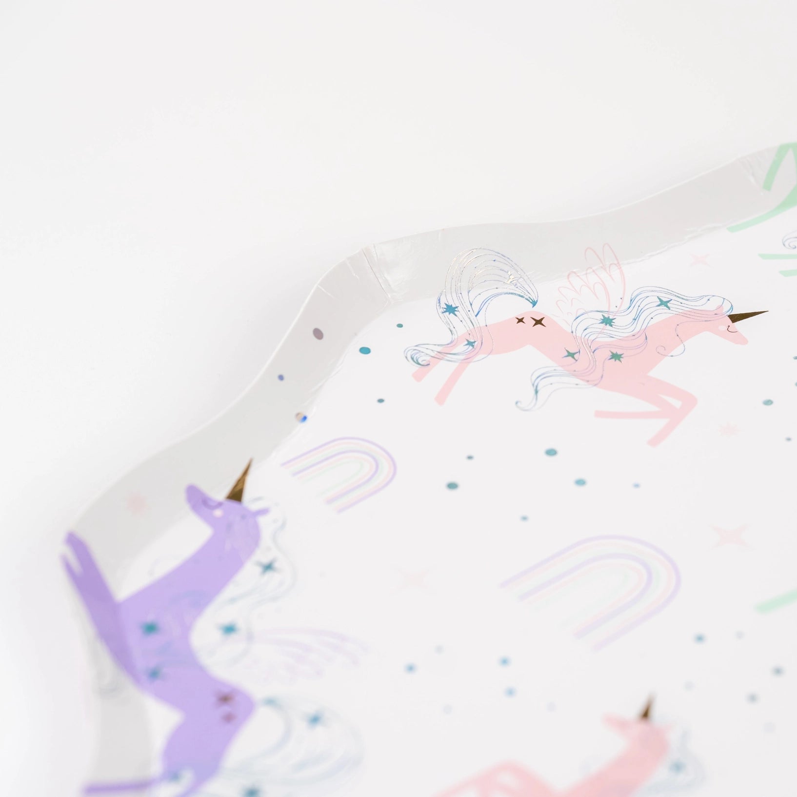 Close detail of holographic mane on pastel unicorn with mini rainbows.