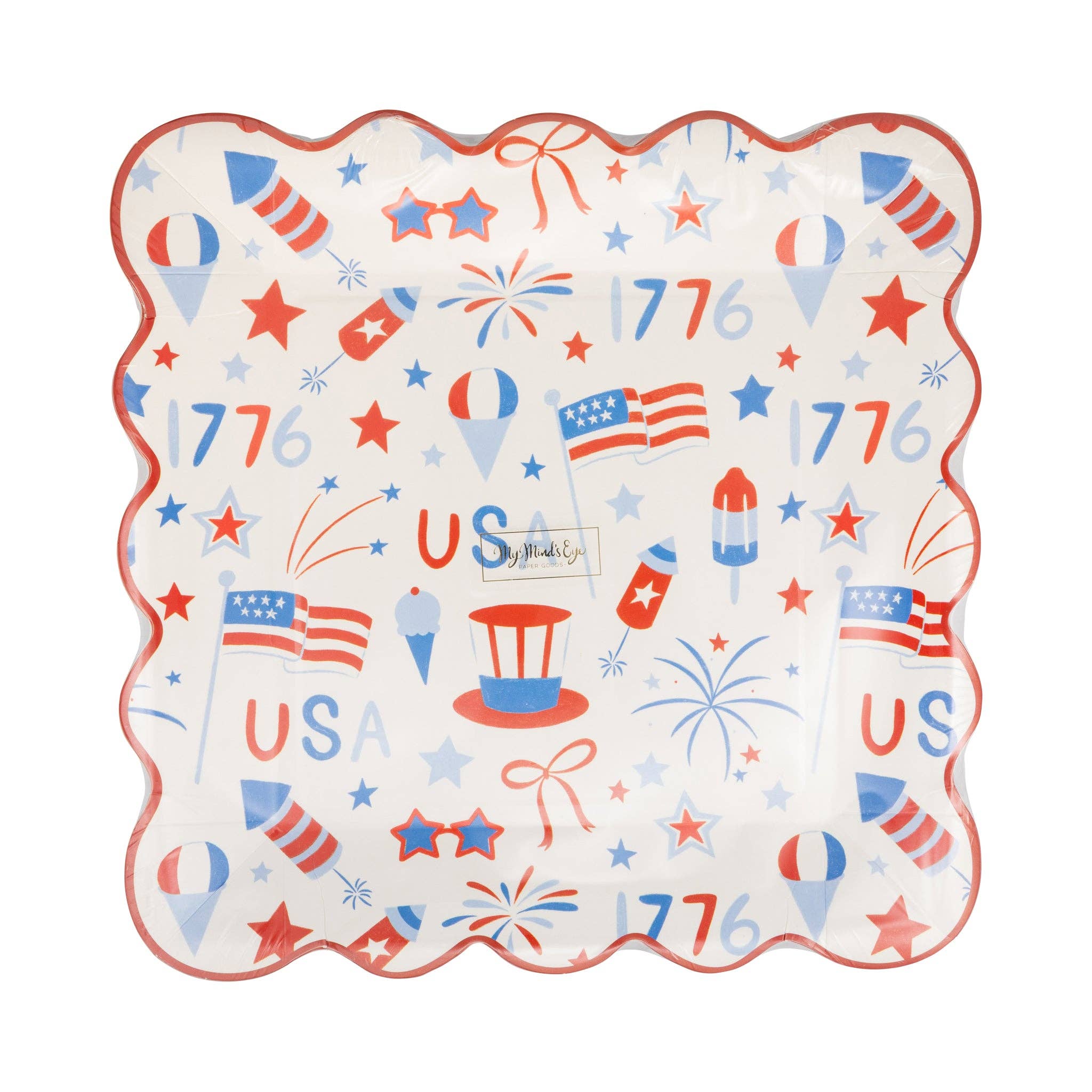 Front view of USA icons scalloped paper plate in packaging showing all-over red white and blue print with flags fireworks stars and 1776