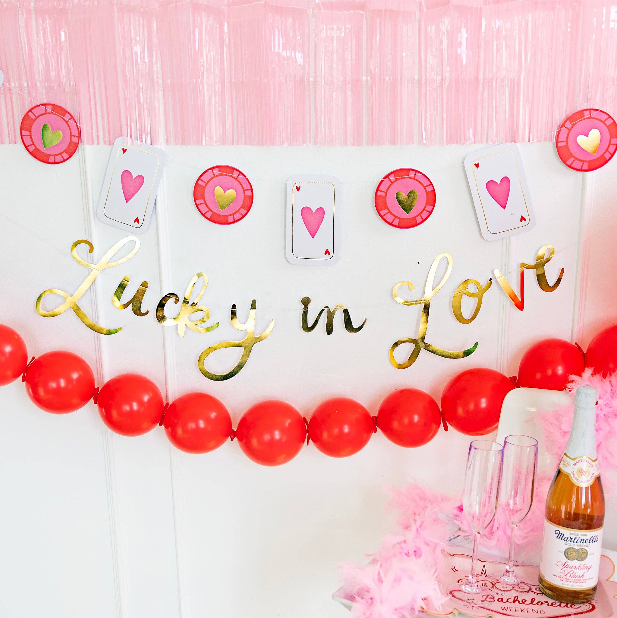 A Lucky in Love Party Sign and coin banner hung as a Vegas suite backdrop for a bachelorette weekend.