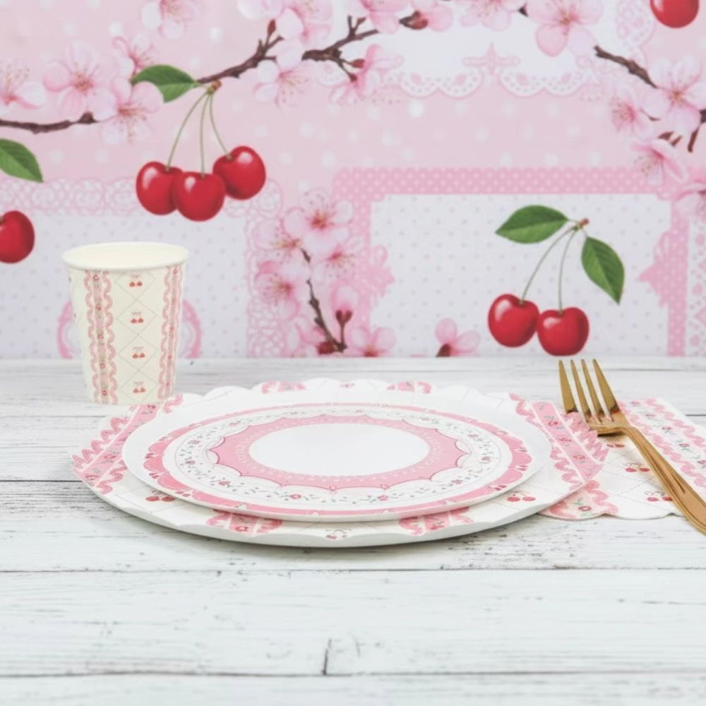 Cherry plate and matching cup on white wood with cherry blossom background