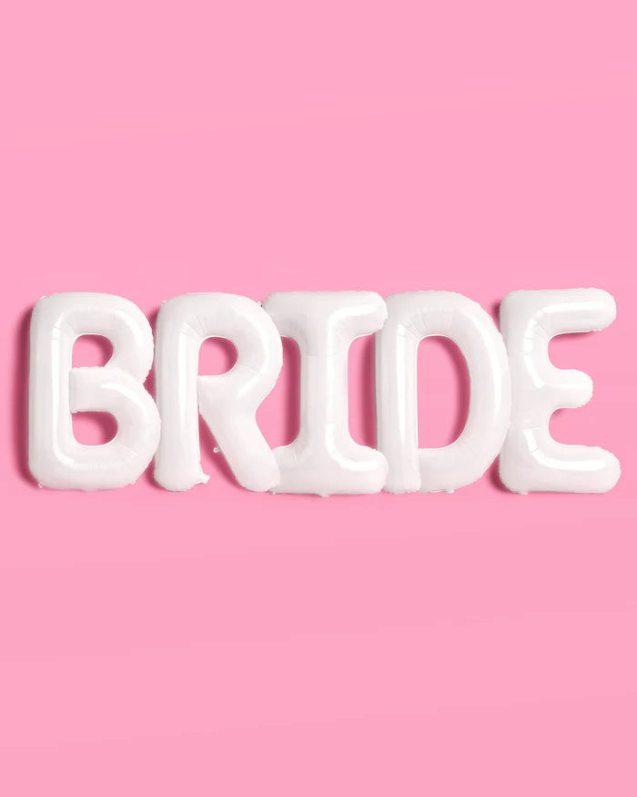 All five white BRIDE letter balloons lined up spelling bride on pink background showing full set and matte mylar finish