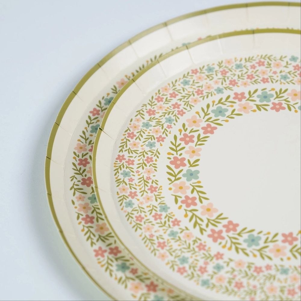 close up of wildflower party plates with floral detailing and gold rim.